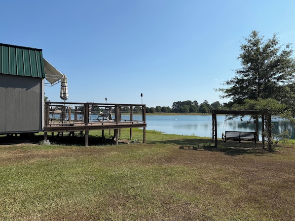 A lakeside deck with outdoor seating and a gazebo. - Little House on the Water at Anderson Farms (Benton)