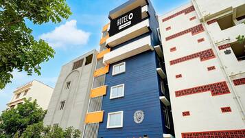 A multi-story hotel building with a prominent 'HOTEL' sign on the facade.