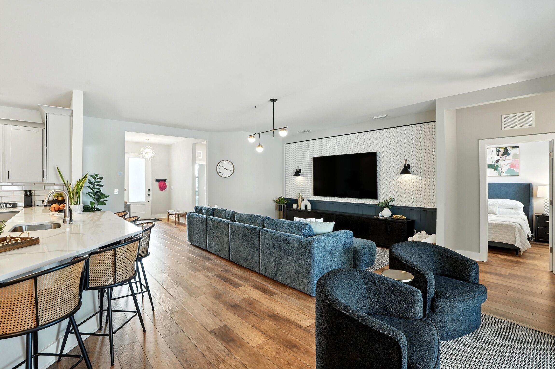 A modern living space with a kitchen, dining area, and seating area.