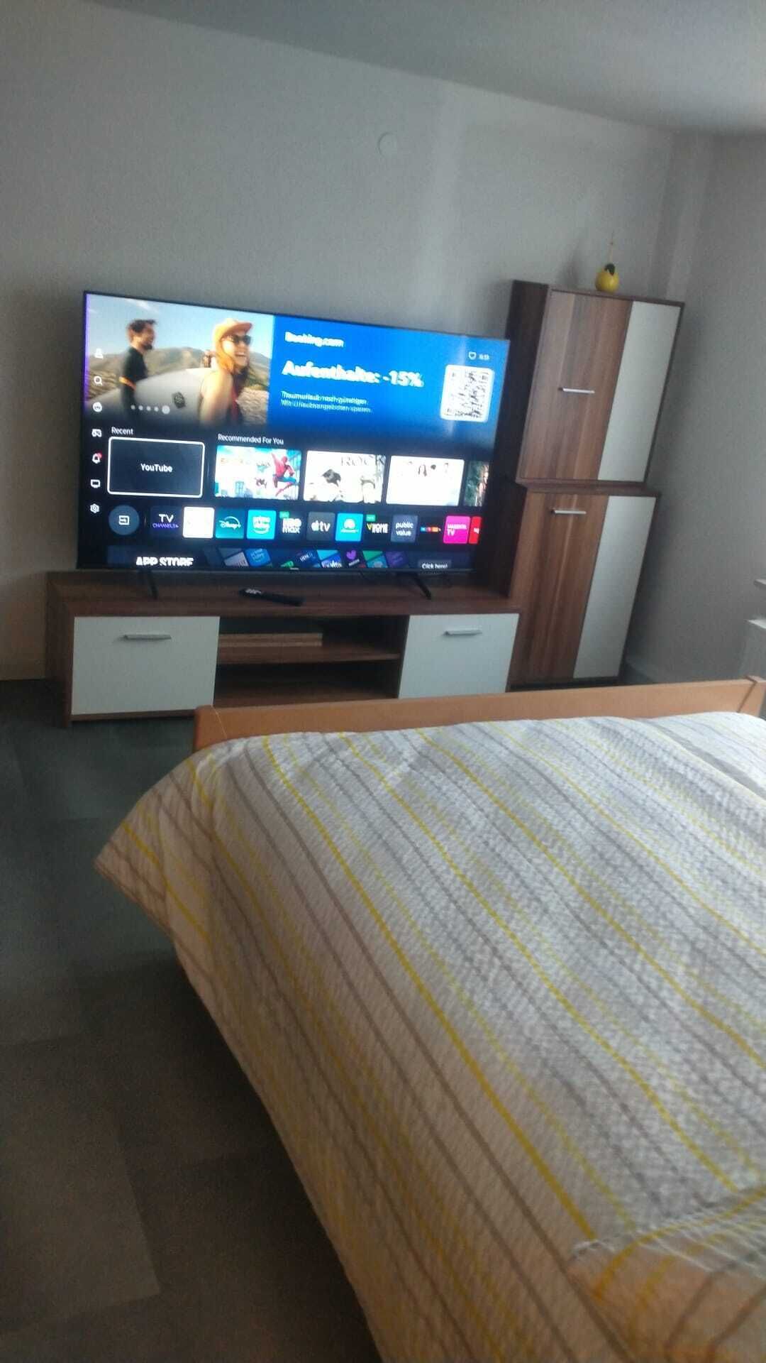 A television displaying a YouTube interface with a promotional offer for a discount.