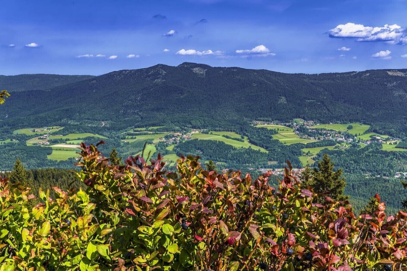 A mountainous landscape with a village in the valley.
