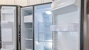 A modern kitchen with white cabinetry and a built-in refrigerator. - Cozy Home | 3BR Near Downtown FW | Sleeps 8 (Fort Worth)