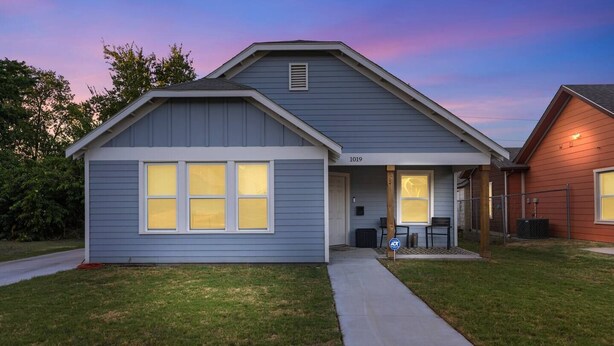 A residential house with a front porch, a covered entryway, and a number '1019' on the front. - Cozy Home | 3BR Near Downtown FW | Sleeps 8 (Fort Worth)