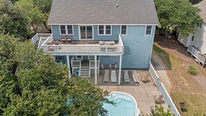 A two-story house with a balcony, a swimming pool, and a fenced yard. - I'm Lov'n Sea and Sand: Dog Friendly | 4Br (Corolla)