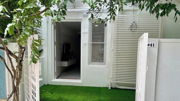 A residential property with a gated entrance, a number sign, and a small artificial green lawn. - Entire rental unit in Bengaluru, India (Bengaluru)