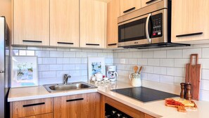 A modern kitchen with wooden cabinets, a stainless steel sink, a microwave, and a coffee maker. - Couples Private Plunge Pool Retreat Near Beach (Punta Cana)