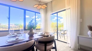 A dining area with a table set for two, a potted plant, and a view of the outdoors. - Couples Private Plunge Pool Retreat Near Beach (Punta Cana)