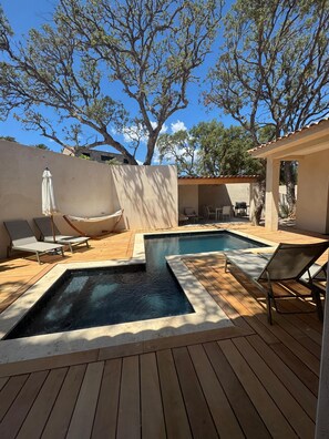 A pool area with lounge chairs and a hammock. - Contemporary 4-bedroom villa—with pool and hot tub—7 minutes from Pinarello (Zonza)