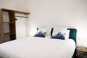 A bedroom with a bed, pillows, a bedside table, and a wardrobe. - Elegant Provençal Wine Estate Surrounded by Vineyards (Le Muy)