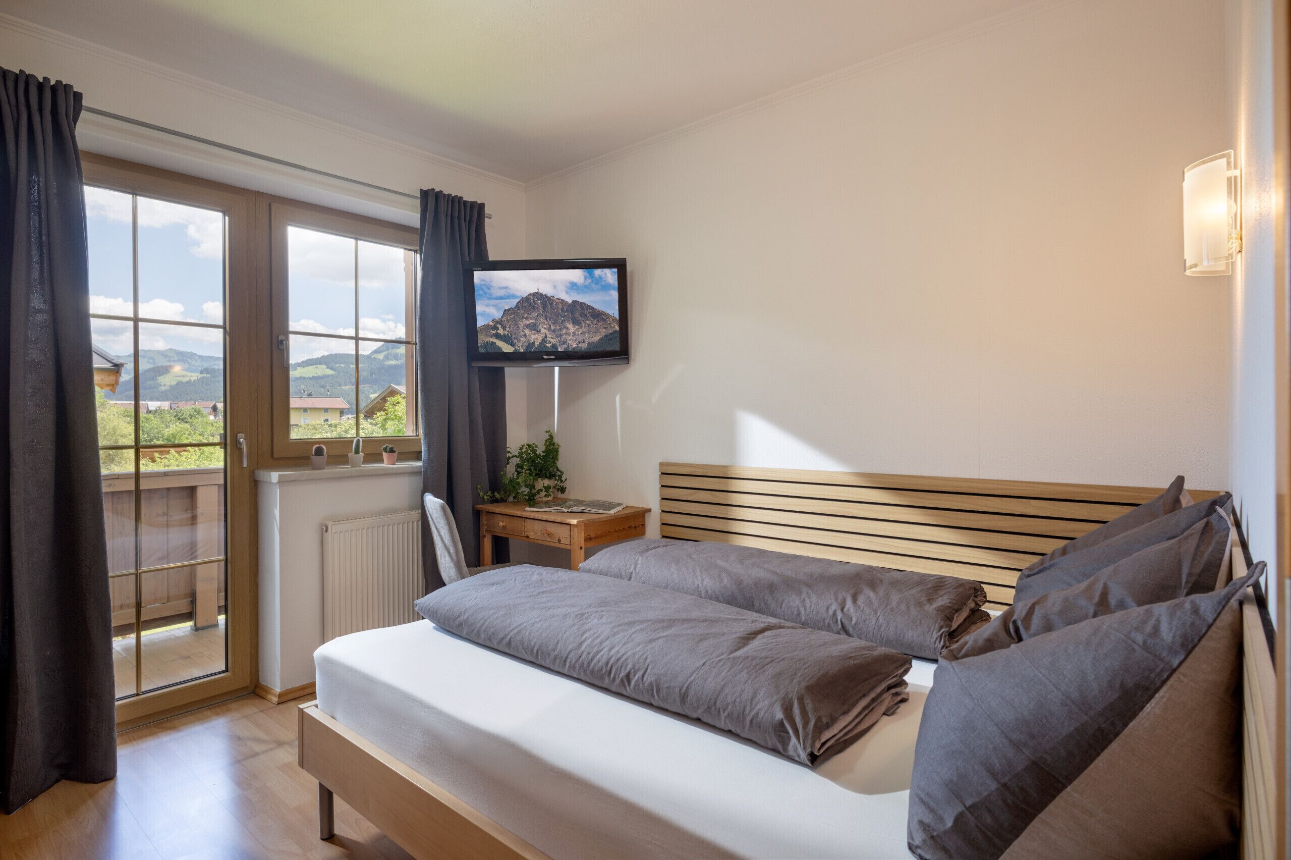Kirchberg in Tirol vacation rental with bedroom, quiet rural surroundings and easy access to ski areas, hiking trails and mountain biking.