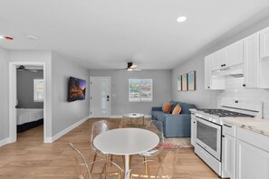 A modern apartment with a kitchen, dining area, and living room. - Vista Home Base | Parking, Near Beaches & Shops (Vista)