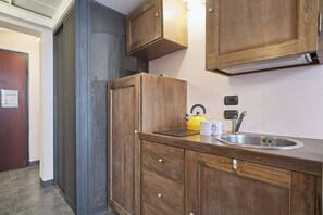 A compact kitchen with a sink, kettle, and cabinets. - Miro al Mare - One Bedroom Apartment, Sleeps 2 (Ceriale)