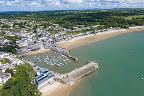 An aerial view of a coastal town with a marina, sandy beach, and residential areas. - Monkstone View - Direct Beach Access (Saundersfoot)