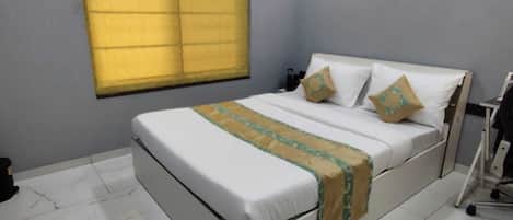A bedroom with a bed, a window with blinds, a ceiling fan, and a tiled floor.