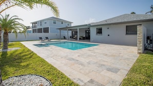 A residential property with a swimming pool, a covered patio, and a two-story house. - Beach Escape, Private Pool ,Sleeps 8 (Fort Myers Beach)