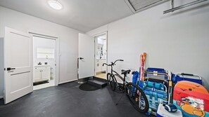A hallway with a bicycle, a stroller, and a colorful play mat. - Cozy Cottage Mins to Siesta Key & Downtown, Hot Tub (Sarasota)
