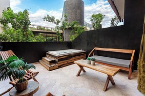 A rooftop terrace with a hot tub, wooden seating, and potted plants. - Private Jacuzzi · Infinity Pool · Tulum Beach Zone (Tulum Municipality)