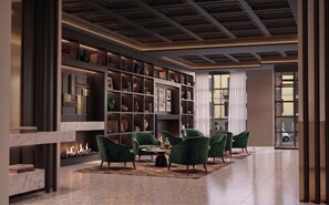 A modern interior with a fireplace, green armchairs, and a bookshelf.