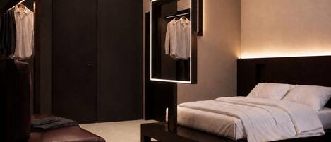 A modern bedroom with a bed, a bench, a wardrobe, and a mirror.