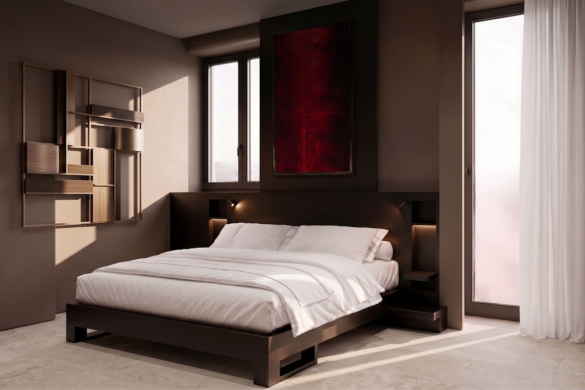 A modern bedroom with a large bed, built-in shelving, and a red accent wall.