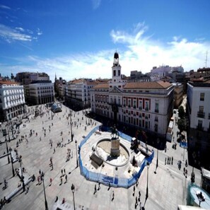 A large open square with a central monument, surrounded by historic buildings.