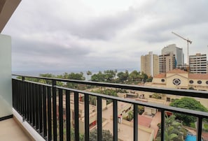 A balcony with a view of a cityscape, including buildings and a construction crane. - w* |  Airy 2BR w/ Balcony in Prime Miraflores (Miraflores)