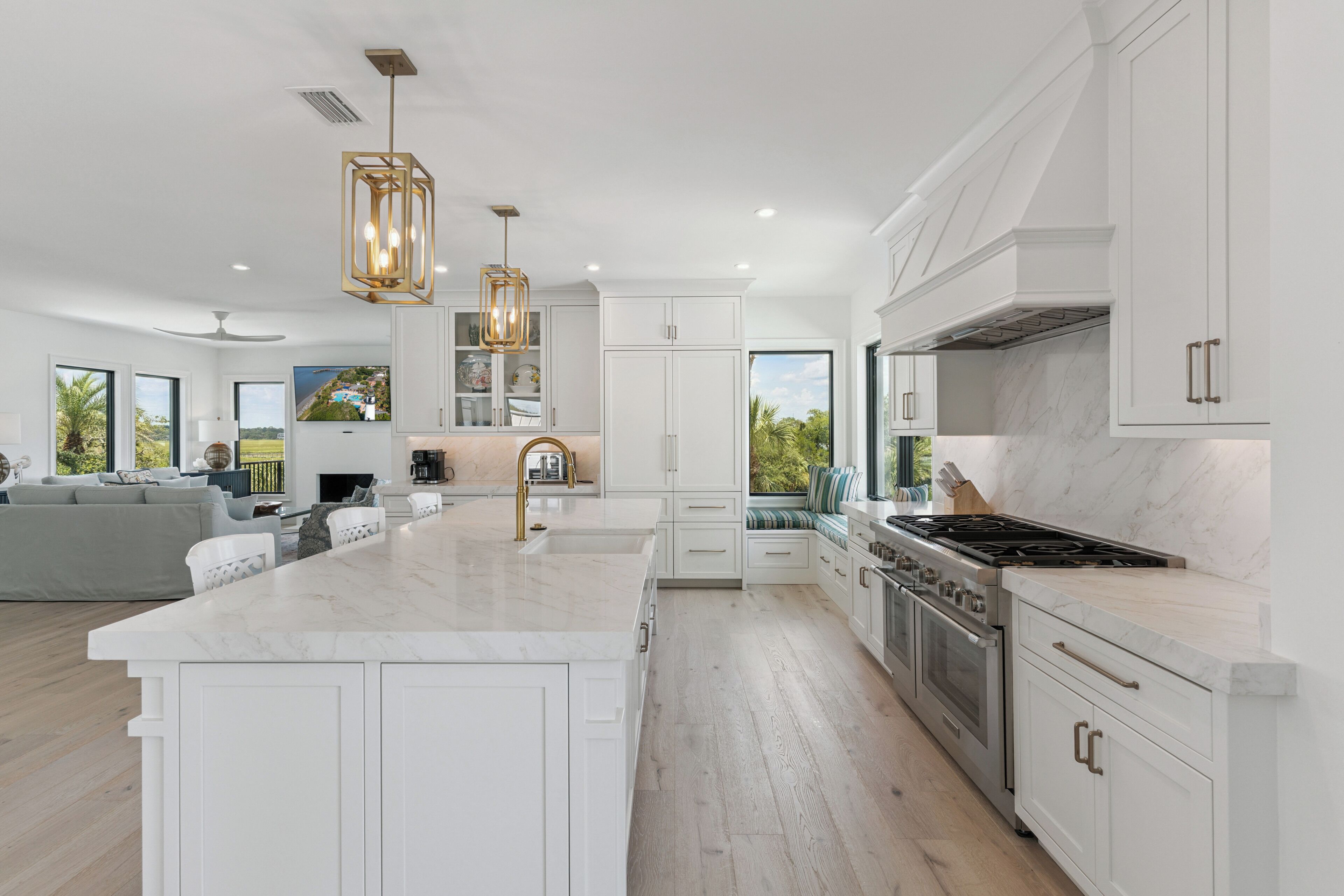 A modern kitchen with a central island, stainless steel appliances, and pendant lighting.