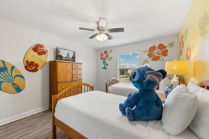 A bedroom with two beds, a ceiling fan, a wooden dresser, and a plush toy on one bed. - Private Pool *Clubhouse Amenities *BBQ Grill (Kissimmee)