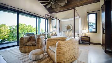 Ein modernes Schlafzimmer mit großem Fenster, Deckenventilator und einem Himmelbett.