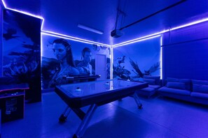 A room with a pool table, a sofa, and a mural. - Spacious Family Escape, Pool & Game Room (Four Corners)