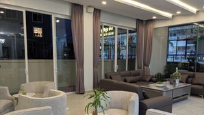 A modern interior with seating arrangements, a coffee table, and a potted plant.