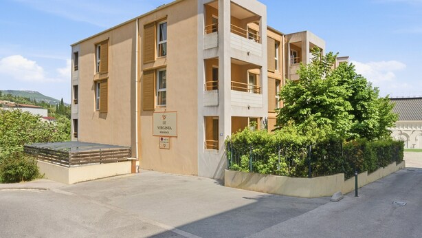 Un edifici modern amb un rètol que diu 'LE VIRGINIA RESIDENCE'.