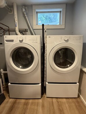 A laundry room with two stacked front-loading washing machines.