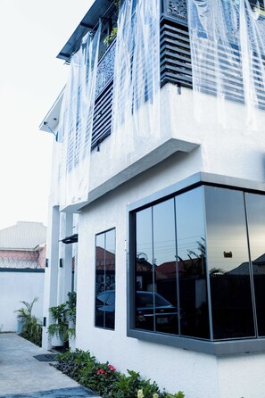 A modern building with large windows and a white exterior.