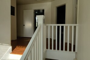 A staircase with white railings leading to a landing. - Downtown Driggs base for Yellowstone/Grand Teton (Driggs)