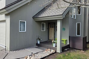 A house with a porch, a door, and a window. - Sleeps 10! Updated Townhome Off Ski Hill Rd (Driggs)