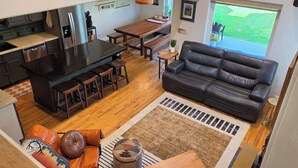 A compact living space with a kitchenette, a dining area, a sofa, and a view of the outdoors. - Sleeps 10! Updated Townhome Off Ski Hill Rd (Driggs)