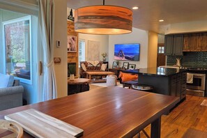 A modern kitchen with dark cabinetry, a built-in oven, and a large island with a sink. - Sleeps 10! Updated Townhome Off Ski Hill Rd (Driggs)