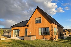 A modern two-story wooden house with large windows and a sloped roof. - White Pine Lodge in Teton Valley (Driggs)