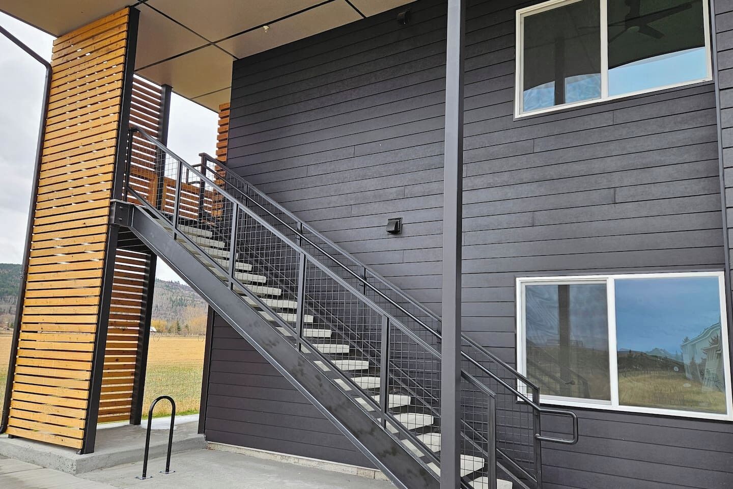 A modern two-story building with a staircase leading to the upper floor.