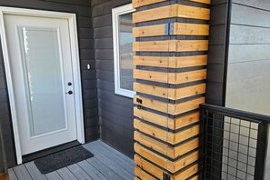 A door with a glass panel, a wooden pillar, and a tiled floor. - Table Rock Condo with huge south deck and a view. (Victor)