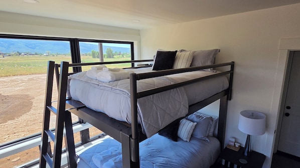 A bunk bed room with a view of a rural landscape. - Teton Valley Retreat (Driggs)
