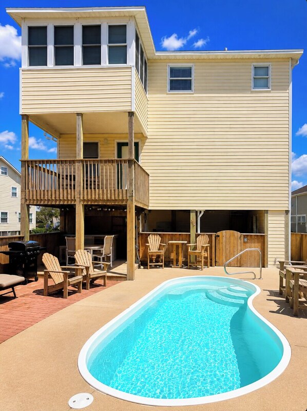 A two-story building with a pool, outdoor seating, and a barbecue area. - Private Pool · 3-Min Walk to Beach · Sleeps 8, Loaded, Pets OK (Nags Head)