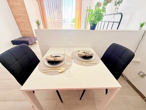 A dining table set with plates, cutlery, and a glass. - Ocean View Serenity Costa Adeje – Studio with a private terrace and ocean views (Costa Adeje)