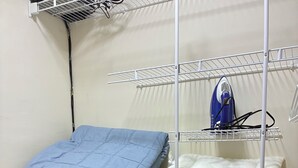 A corner of a room with a bed, a blue mattress, a white mattress, and a blue chair. - 3-Bedroom Villa Near the Beaches / Pool / Gym / Near Downtown Punta Cana (Punta Cana)