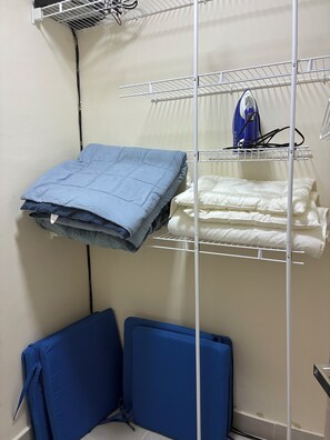 A corner of a room with a bed, a blue mattress, a white mattress, and a blue chair. - 3-Bedroom Villa Near the Beaches / Pool / Gym / Near Downtown Punta Cana (Punta Cana)