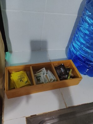 A wooden box containing various items, including a yellow packet labeled 'Barilla' and several other packets with text. - Perfect Budget studio apartment in awesome Rungiri neighborhood (Rungiri)