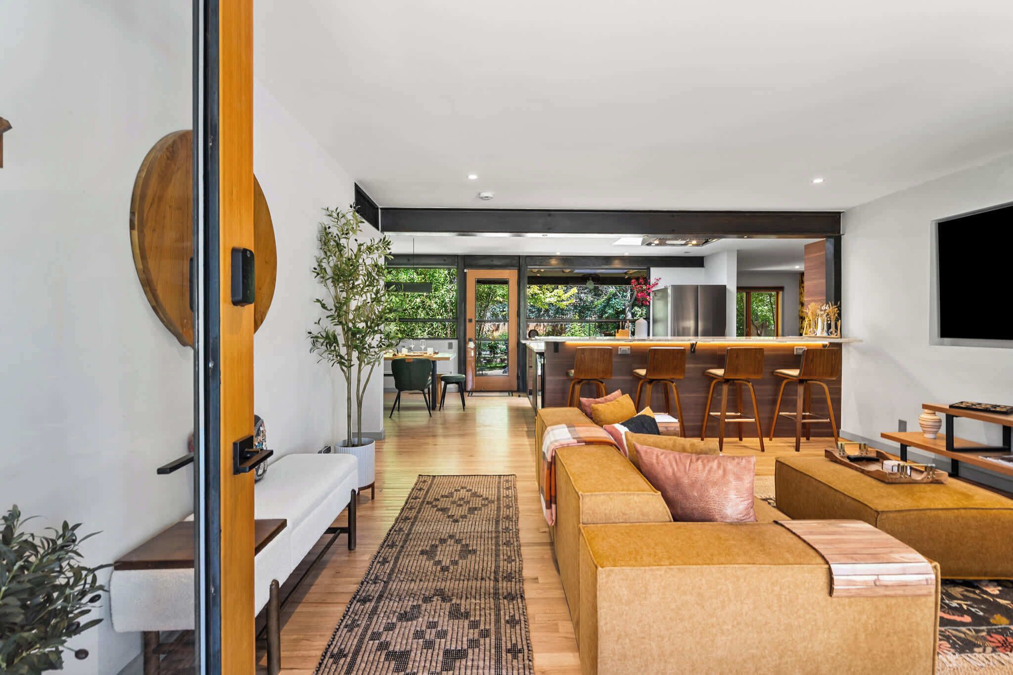 A modern interior with a living area, kitchen, and dining space.