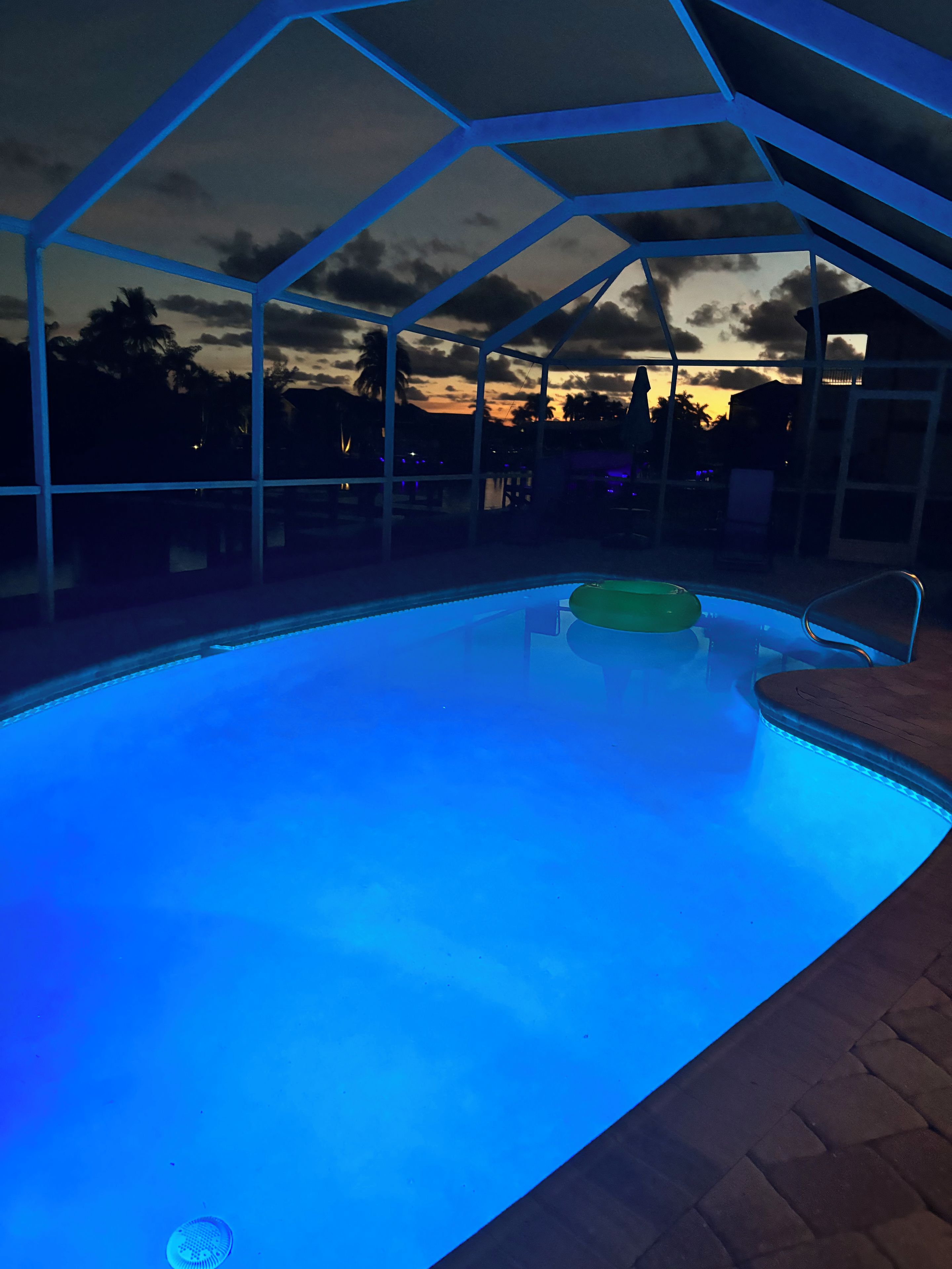 A swimming pool with a clear view of the sky and surrounding buildings.