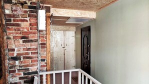 A staircase with a white railing leading to a door with a black frame.